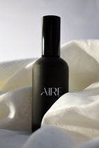 Linen Aire & Co home fragrance mist bottle surrounded by white fabric