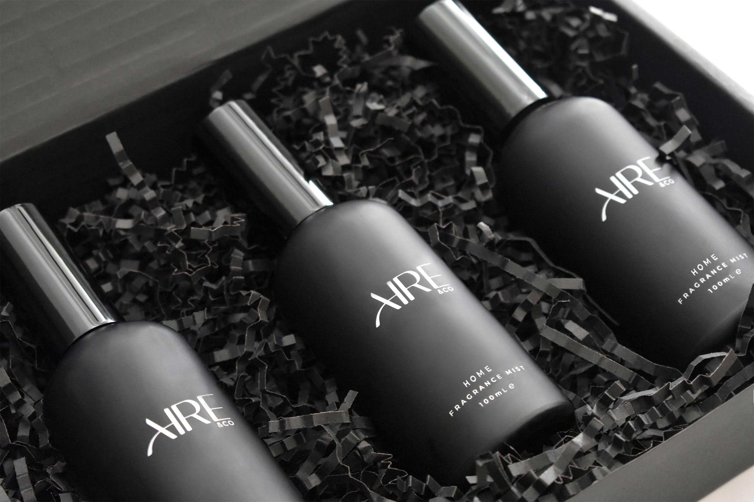 Three Aire & Co home fragrance mist bottles inside black packaged box.
